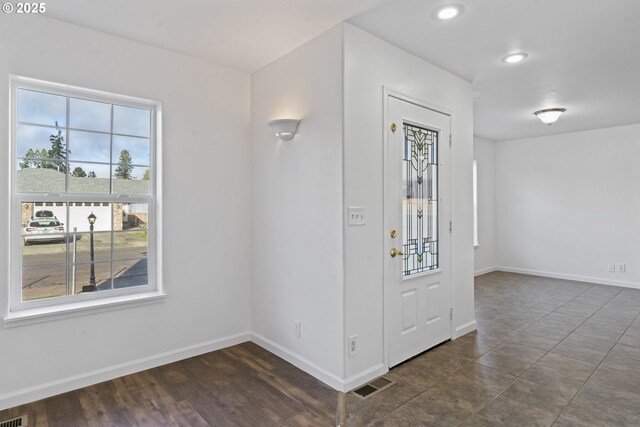 unfurnished living room featuring dark wood-type flooring and french doors