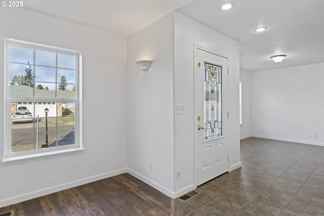 entryway with baseboards, visible vents, and a healthy amount of sunlight