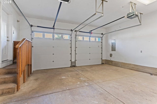 garage featuring electric panel and a garage door opener