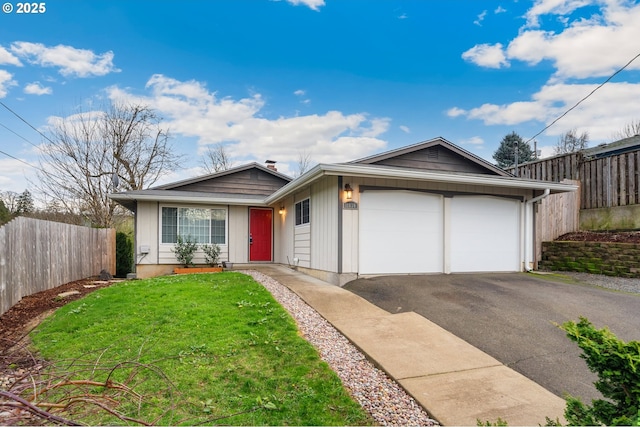 single story home with a garage and a front lawn