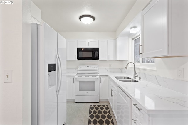 kitchen with white appliances, white cabinetry, and sink