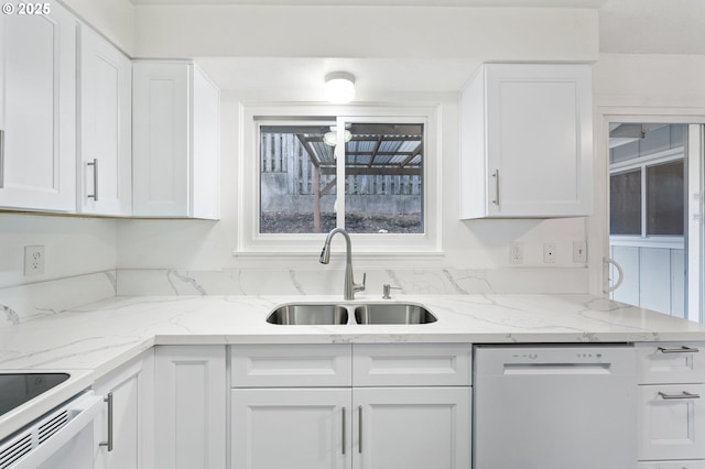 kitchen featuring dishwasher, white cabinetry, light stone countertops, and sink