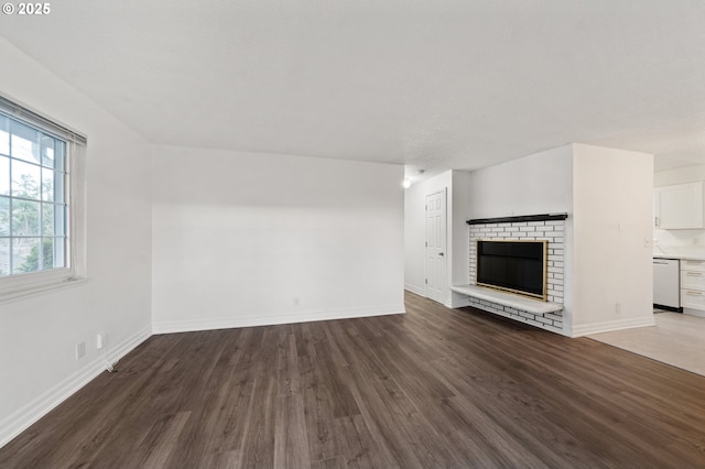 unfurnished living room with dark hardwood / wood-style floors and a fireplace