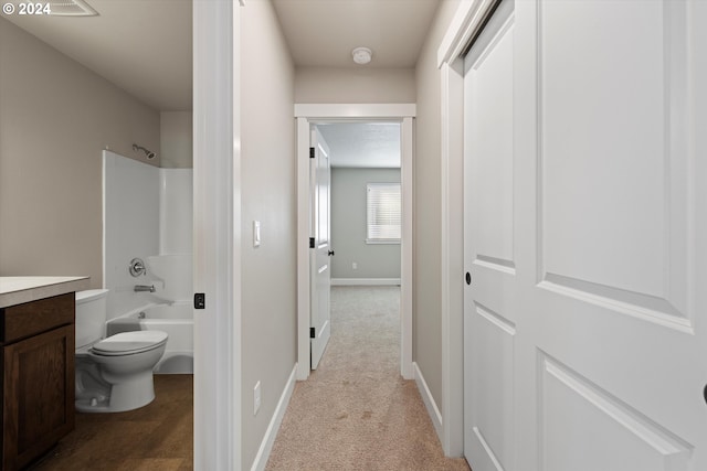 interior space with shower / bathing tub combination, vanity, and toilet