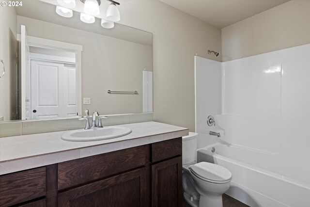 full bathroom with tub / shower combination, vanity, and toilet