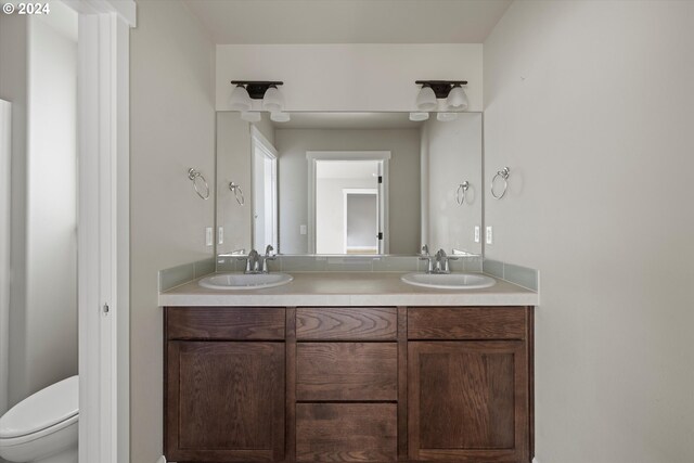 bathroom featuring vanity and toilet