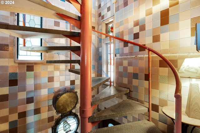 stairway with tile walls