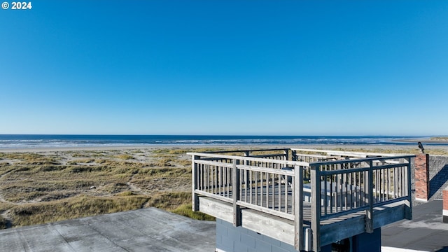 exterior space featuring a water view and a view of the beach