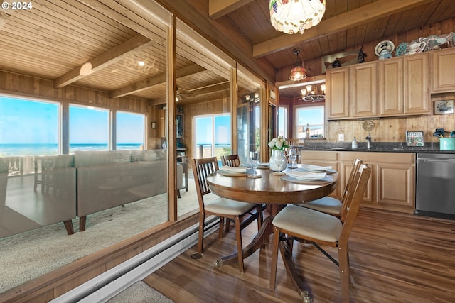 dining area featuring a wealth of natural light, beamed ceiling, a water view, and wood-type flooring