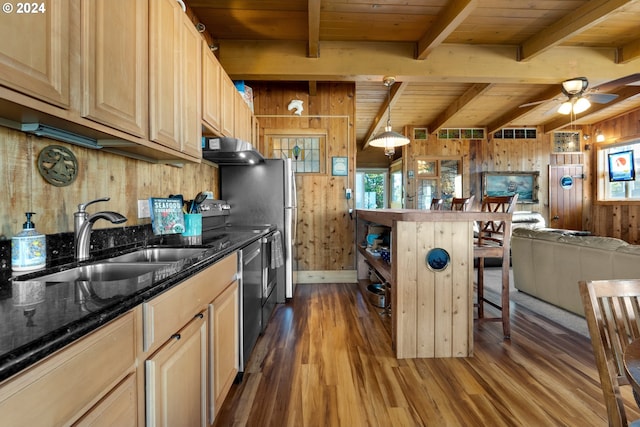 kitchen featuring dark wood-type flooring, wood walls, sink, wooden ceiling, and light brown cabinetry