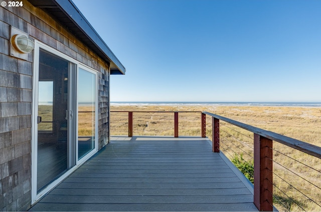 wooden terrace with a beach view and a water view