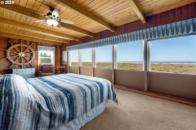 carpeted bedroom featuring wooden ceiling, ceiling fan, beam ceiling, and a water view