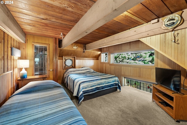 carpeted bedroom with beamed ceiling, wooden walls, and wood ceiling