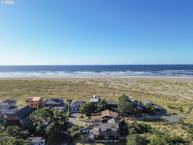 drone / aerial view featuring a beach view and a water view