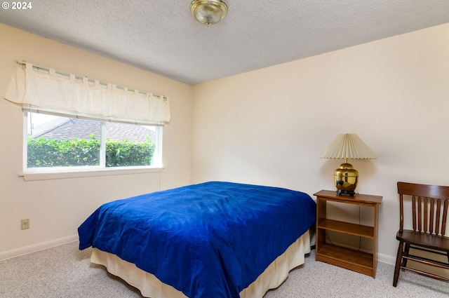 carpeted bedroom with a textured ceiling