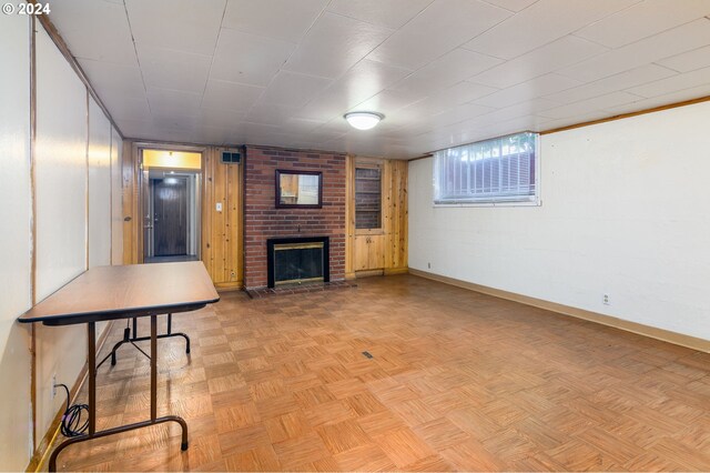 living room with light parquet floors and a brick fireplace