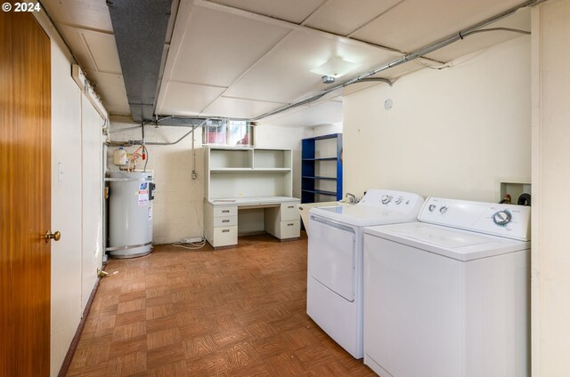 washroom featuring parquet flooring, water heater, and washing machine and dryer