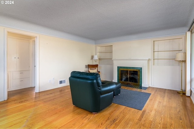 living room with a textured ceiling and hardwood / wood-style floors