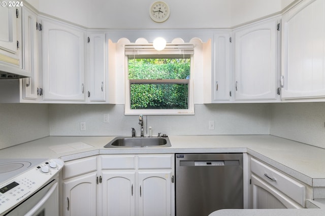 kitchen with stainless steel dishwasher, sink, and white cabinetry