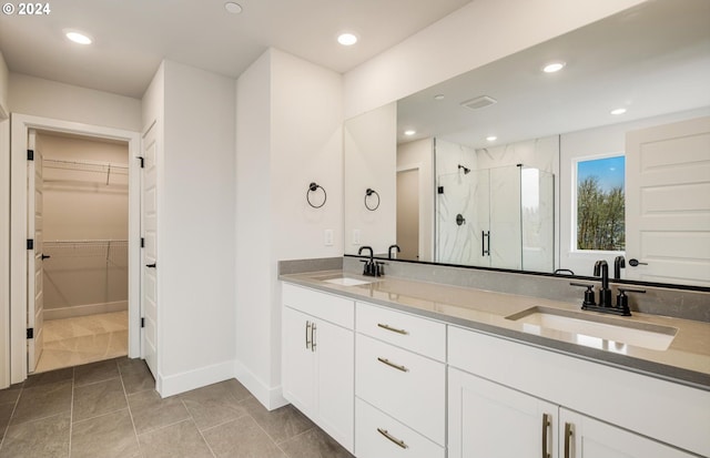 17477 NW Antonio St, Portland, OR 97229 - bathroom with baseboards, a sink, a walk in closet, and a stall shower