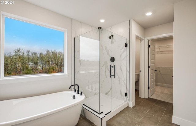 17477 NW Antonio St, Portland, OR 97229 - bathroom featuring recessed lighting, a marble finish shower, a walk in closet, and a soaking tub