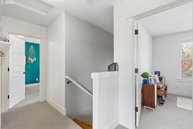 hall featuring light colored carpet