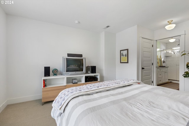 carpeted bedroom featuring ensuite bathroom