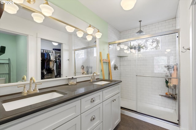 bathroom with vanity, a shower with shower door, and tile patterned floors