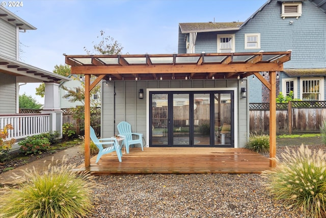 back of property with a wooden deck and a pergola