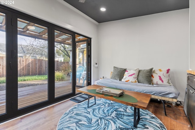 living room featuring light hardwood / wood-style floors and ornamental molding