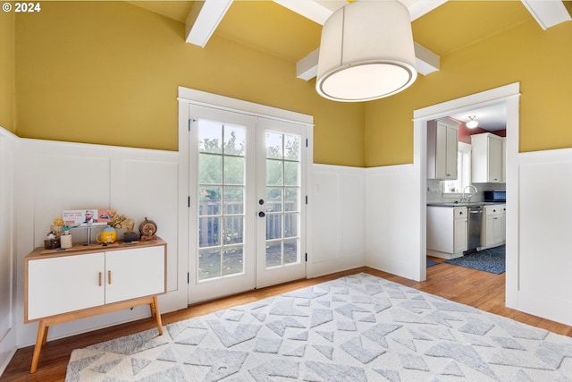 doorway featuring sink, beamed ceiling, french doors, and light hardwood / wood-style floors