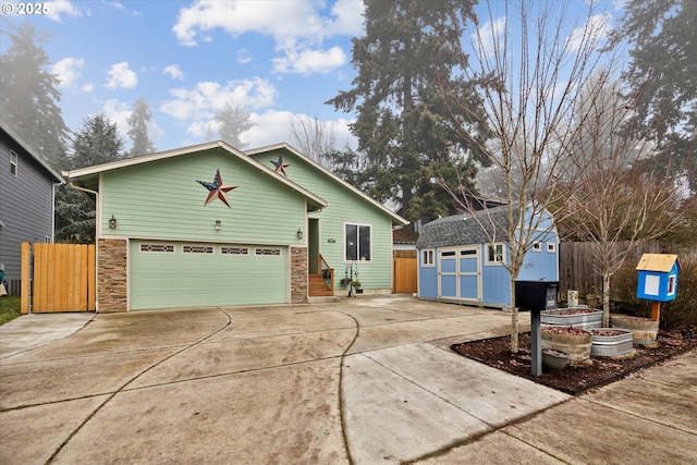 view of front of house with a garage and a storage unit