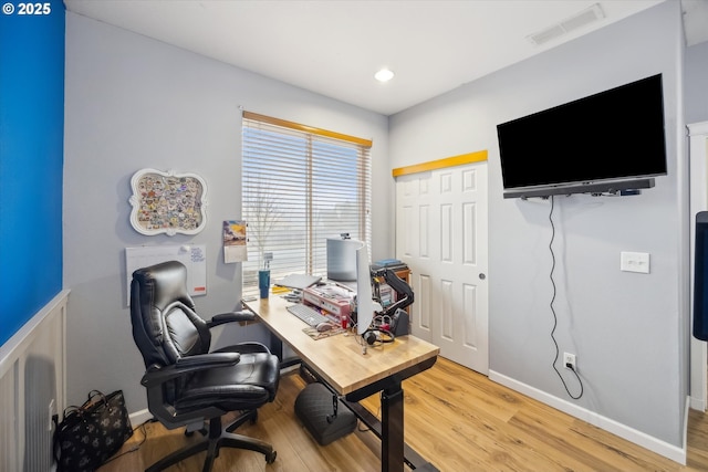 home office with hardwood / wood-style floors