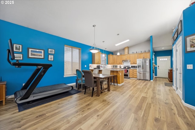 dining room with lofted ceiling and light hardwood / wood-style flooring