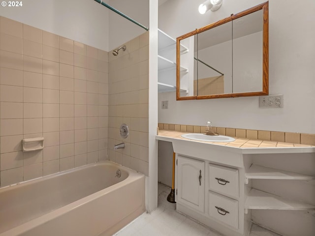 bathroom with vanity and tiled shower / bath combo