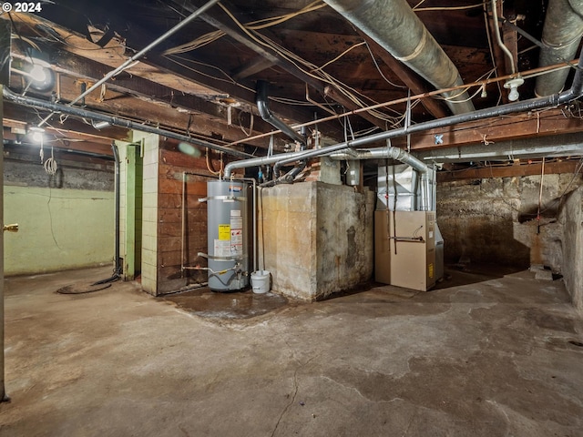 basement featuring water heater and heating unit