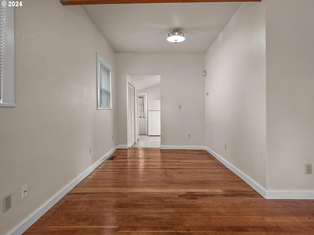 hallway with hardwood / wood-style flooring