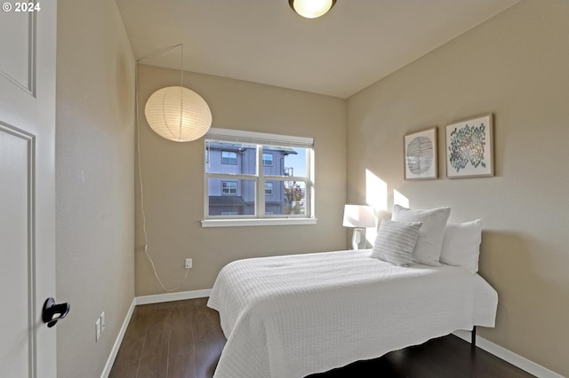 bedroom with dark hardwood / wood-style flooring