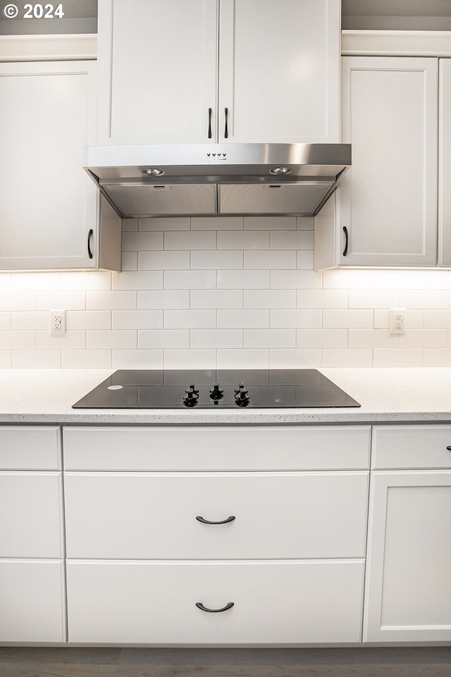 kitchen featuring white cabinetry and black electric stovetop