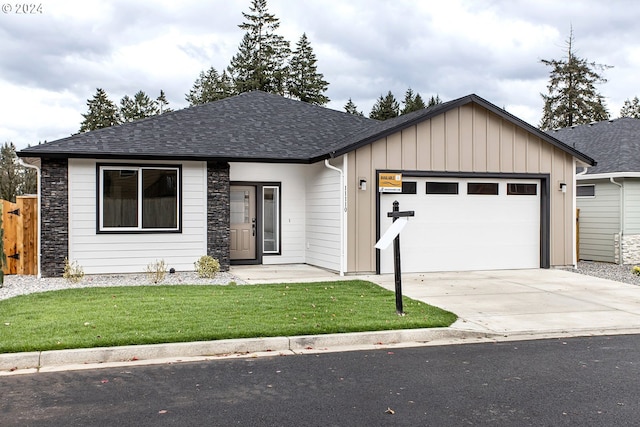 view of front facade featuring a garage, a shingled roof, stone siding, driveway, and board and batten siding