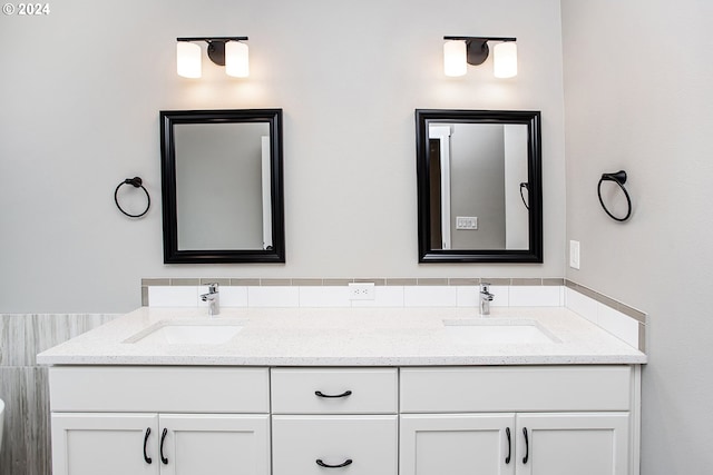 bathroom with double vanity and a sink