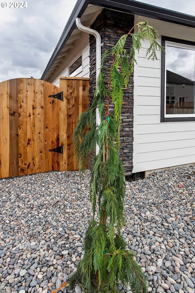 view of side of property featuring fence