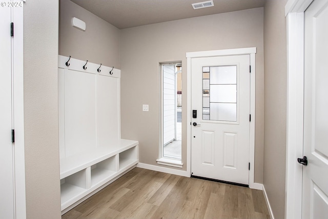 mudroom with light wood-style flooring, visible vents, and baseboards