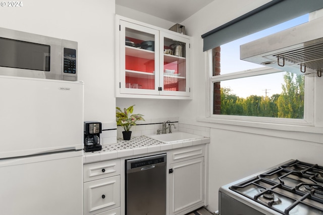 kitchen with sink, white cabinets, and appliances with stainless steel finishes