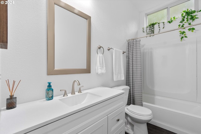 full bathroom with shower / bath combination with curtain, vanity, and toilet