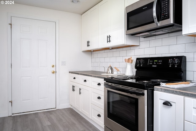 kitchen featuring decorative backsplash, light wood-type flooring, white cabinetry, and stainless steel appliances