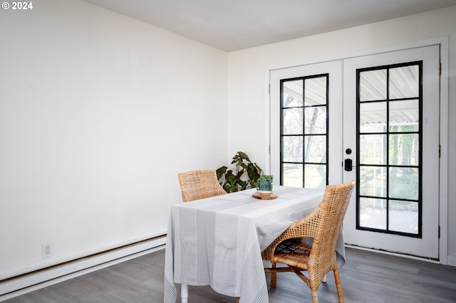 dining space featuring dark hardwood / wood-style flooring, french doors, and a baseboard heating unit