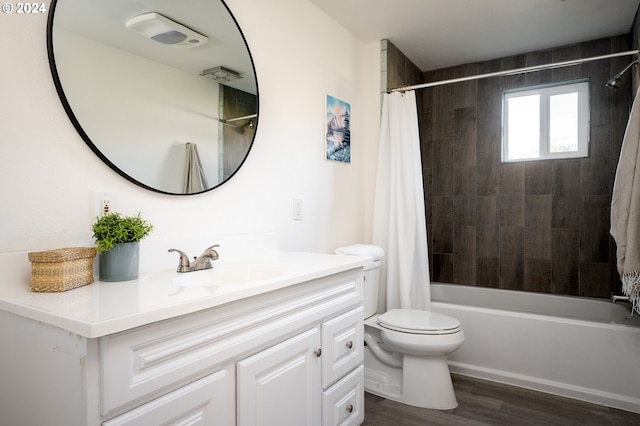 full bathroom with shower / tub combo, vanity, hardwood / wood-style flooring, and toilet