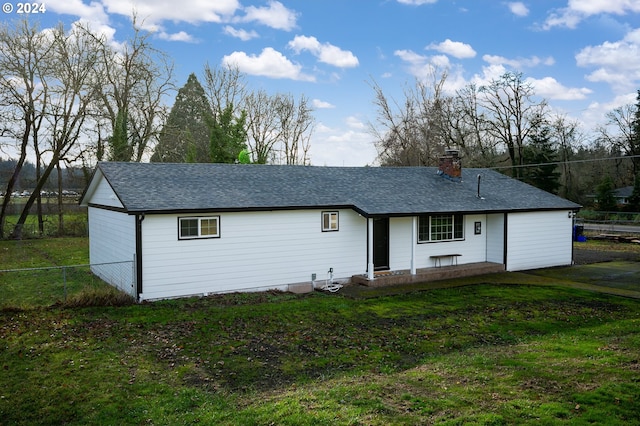 back of house featuring a lawn