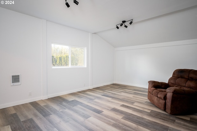 sitting room featuring lofted ceiling and light wood-type flooring